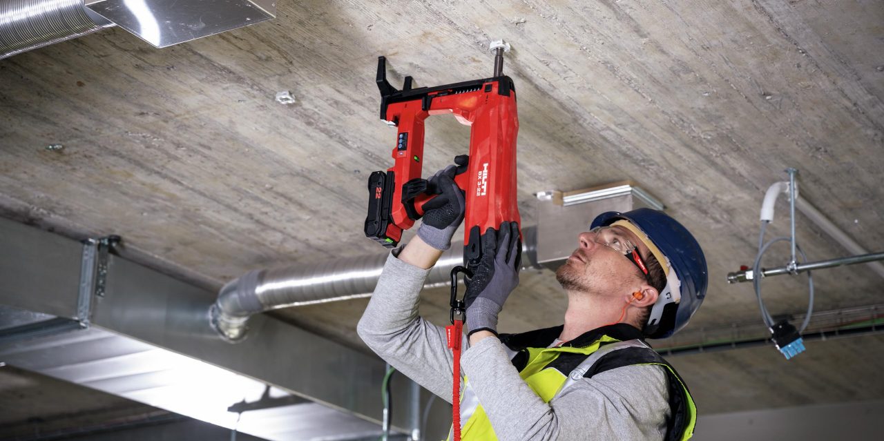 BX 3 battery-powered nailer, a virtually dust-free alternative to drilling, being used to fasten on concrete
