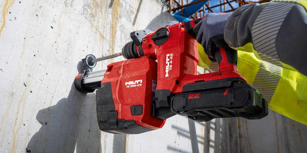 Construction worker using a TE 6-22Cordless combihammer  with Active Torque Control (ATC) to help prevent kickback