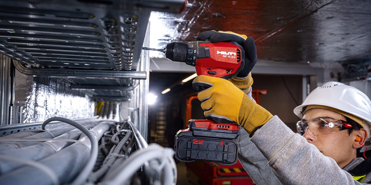 Construction worker using a n SF 4-22 Cordless hammer drill driver with Active Torque Control (ATC) to help prevent kickback